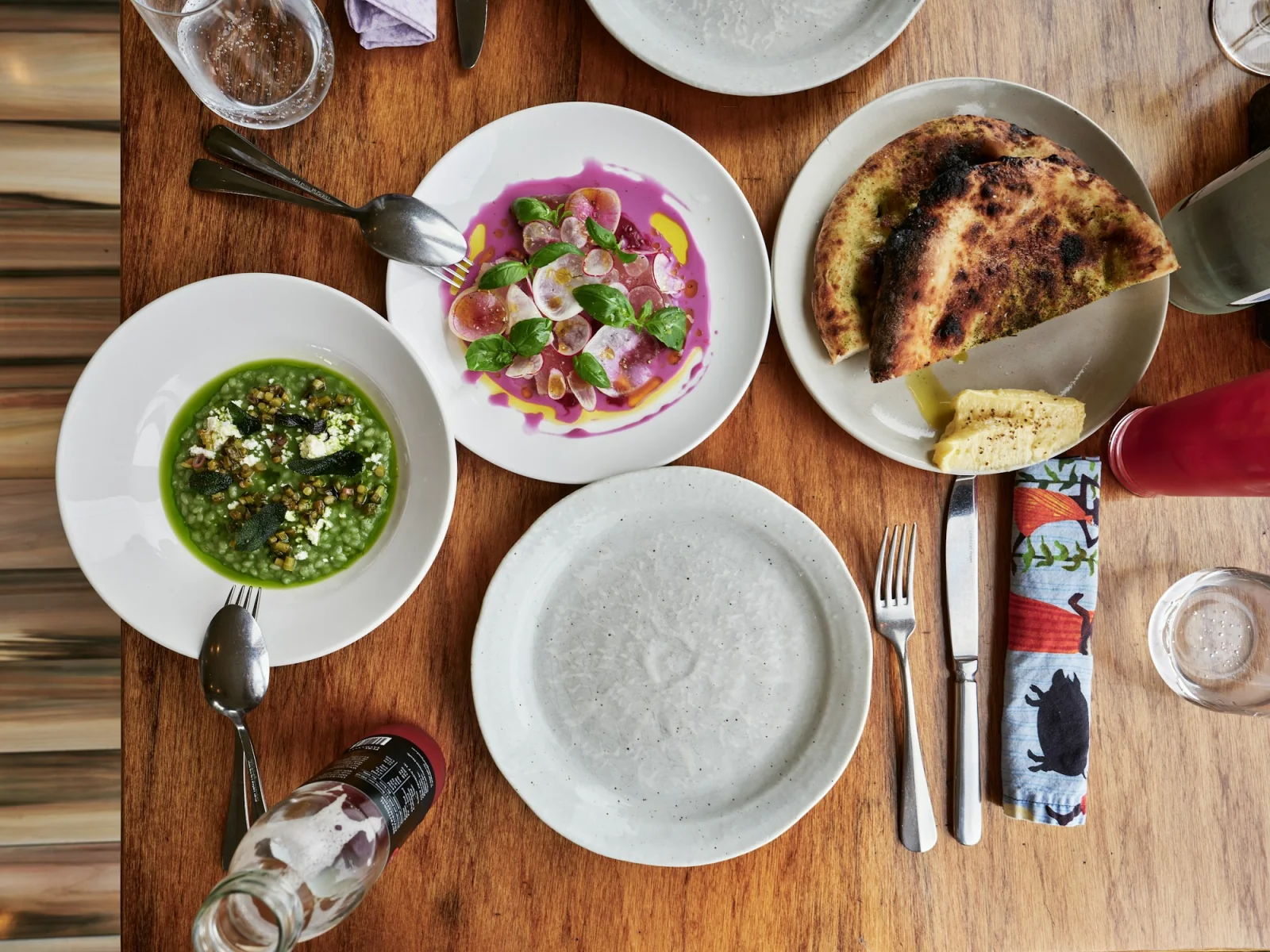 Seasonal dishes, vegetables and herbs arranged for a shared meal.